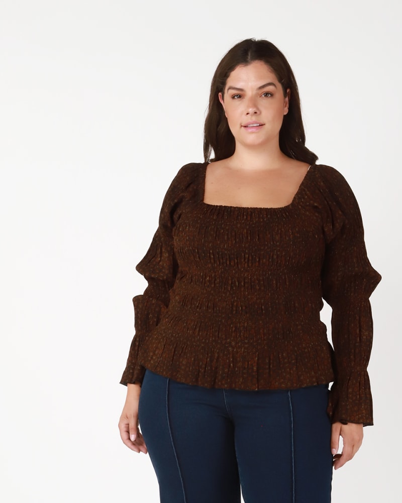 Front of a model wearing a size 0X Elsa Plisse Puff Sleeve Top in Brown / Orange by DEX PLUS. | dia_product_style_image_id:233928